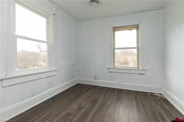 empty room with dark hardwood / wood-style flooring