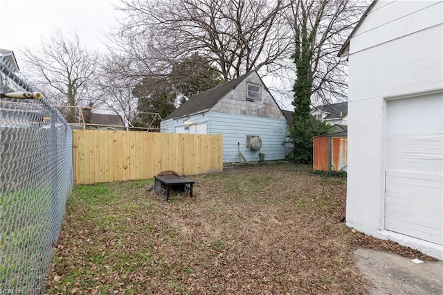 view of yard with an outdoor fire pit