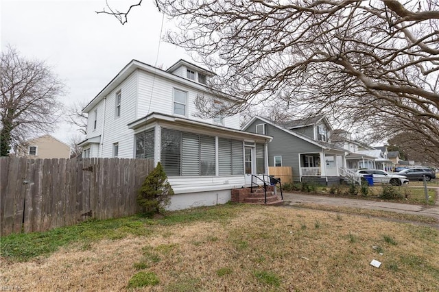 view of property featuring a front lawn