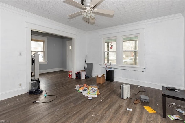 interior space featuring dark wood-type flooring, plenty of natural light, and crown molding