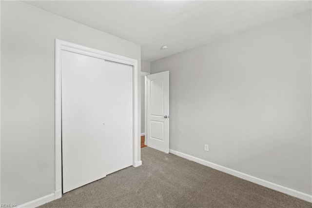 unfurnished bedroom featuring a closet and carpet flooring