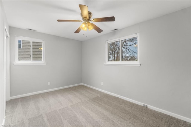 spare room featuring light carpet and ceiling fan