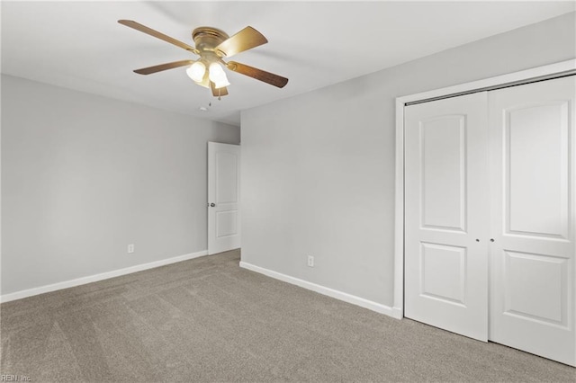 unfurnished bedroom with light colored carpet, ceiling fan, and a closet