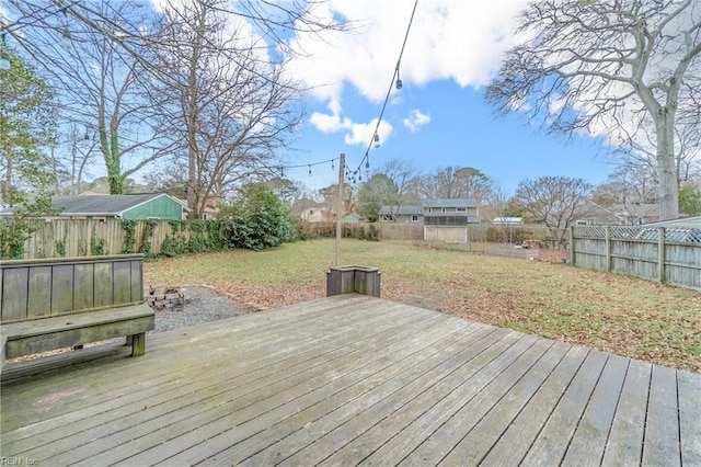 wooden deck featuring a lawn