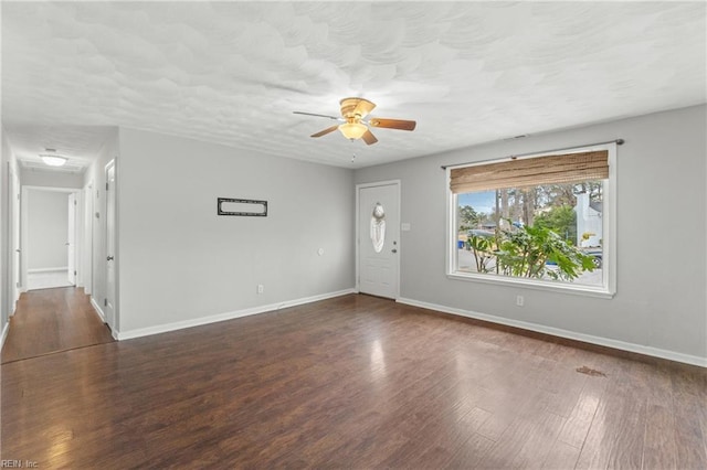 unfurnished room with dark hardwood / wood-style floors, a textured ceiling, and ceiling fan