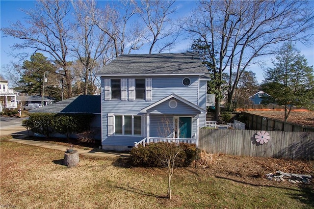 view of front of house with a porch and a front yard