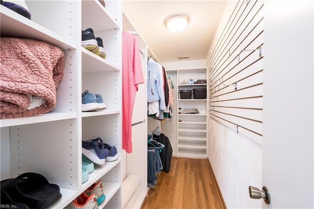 spacious closet with light hardwood / wood-style flooring