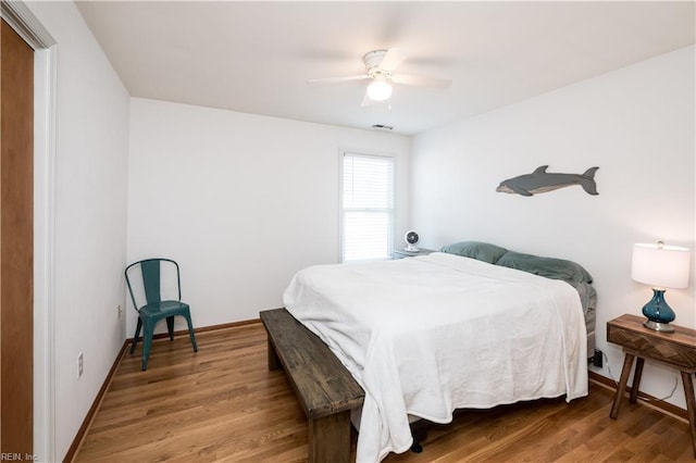 bedroom with ceiling fan and wood-type flooring