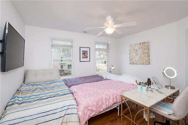 bedroom with ceiling fan and wood-type flooring