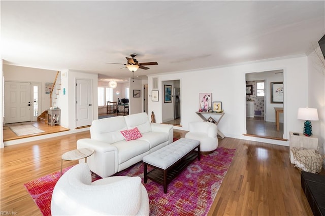 living room with wood-type flooring and ceiling fan