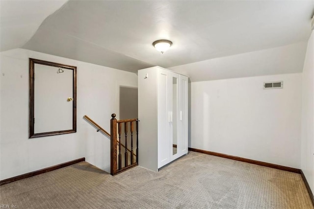 additional living space with lofted ceiling and light colored carpet