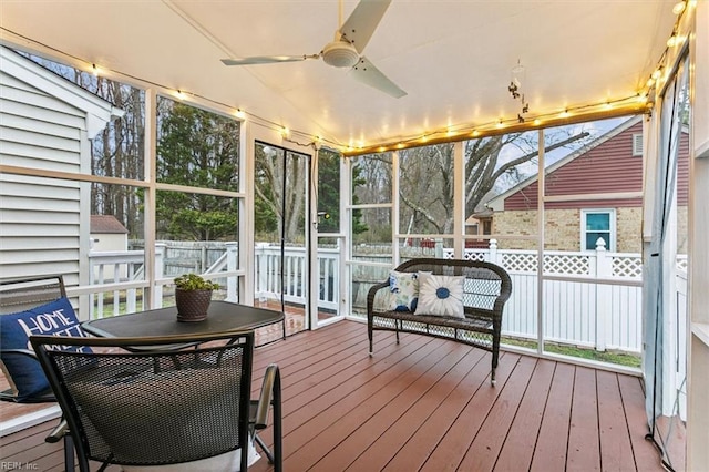 sunroom / solarium with ceiling fan