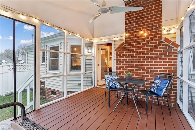 unfurnished sunroom featuring plenty of natural light and ceiling fan