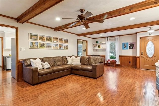 living room featuring crown molding, hardwood / wood-style floors, ceiling fan, and beam ceiling