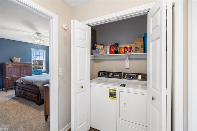 laundry room with ceiling fan, carpet floors, and washing machine and clothes dryer