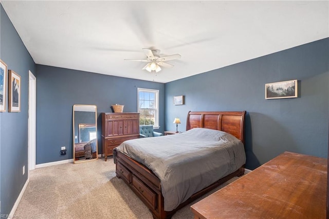 bedroom with ceiling fan and light carpet