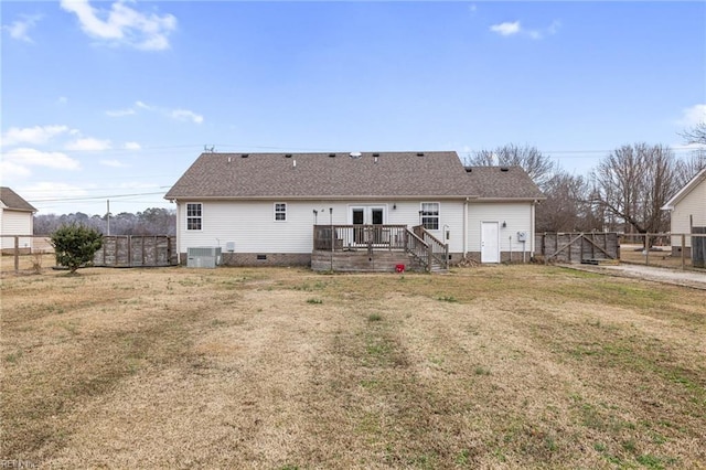 back of house with a wooden deck, central AC, and a lawn