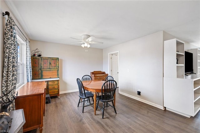 dining area featuring dark wood-type flooring and ceiling fan