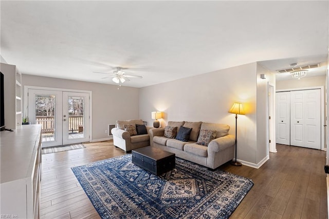 living room featuring dark wood-type flooring, ceiling fan, and french doors