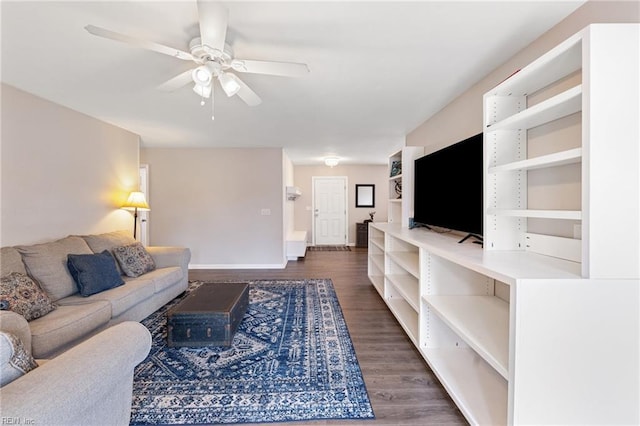 living room featuring dark hardwood / wood-style flooring and ceiling fan