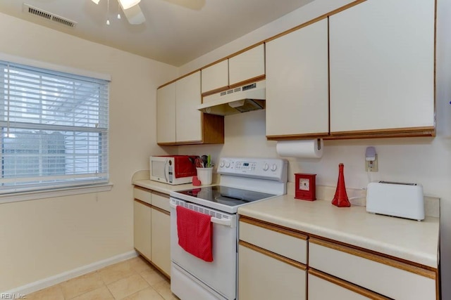 kitchen featuring light tile patterned flooring, white appliances, ceiling fan, and white cabinets