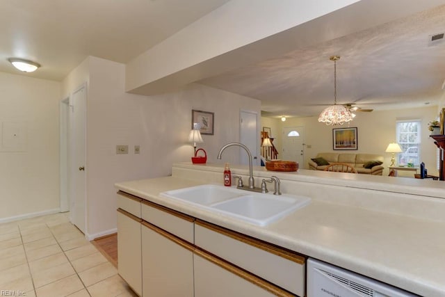 kitchen with dishwashing machine, sink, white cabinets, and light tile patterned flooring