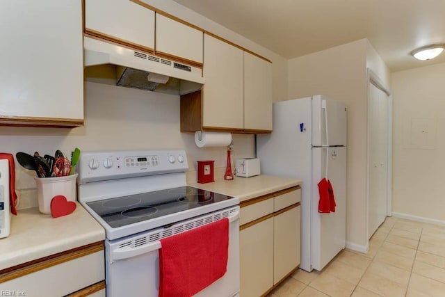 kitchen with white cabinets, white appliances, and light tile patterned floors