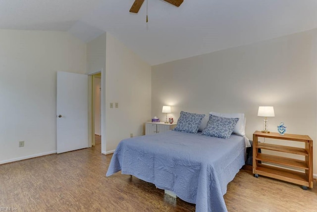 bedroom featuring ceiling fan, lofted ceiling, and light hardwood / wood-style flooring