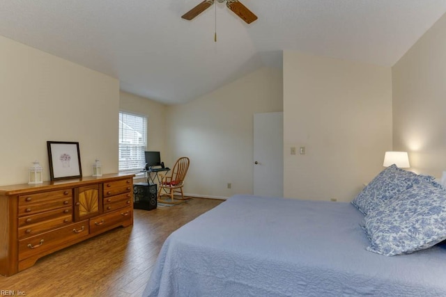 bedroom with lofted ceiling, hardwood / wood-style floors, and ceiling fan