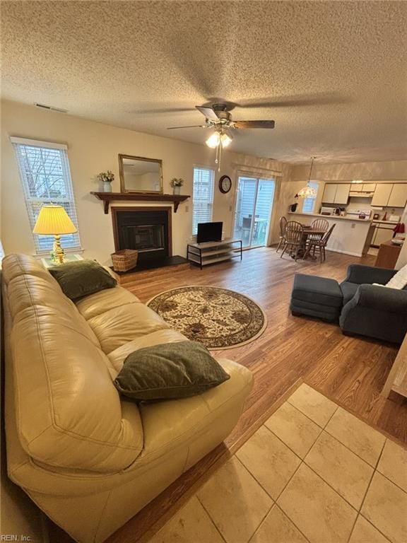 living room featuring hardwood / wood-style flooring, a textured ceiling, and a wealth of natural light