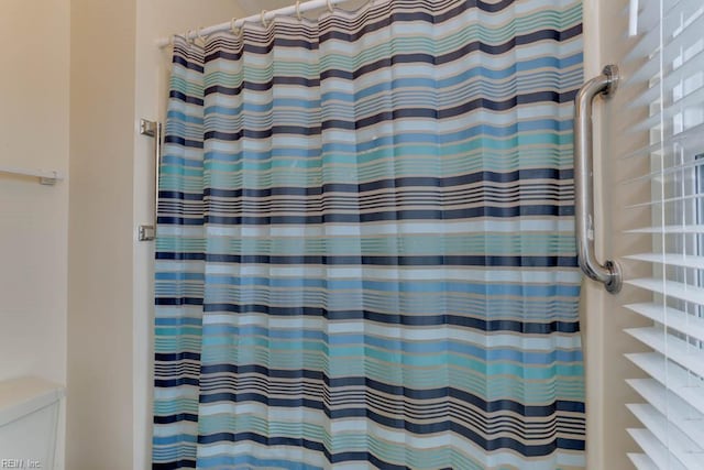 bathroom featuring a shower with curtain