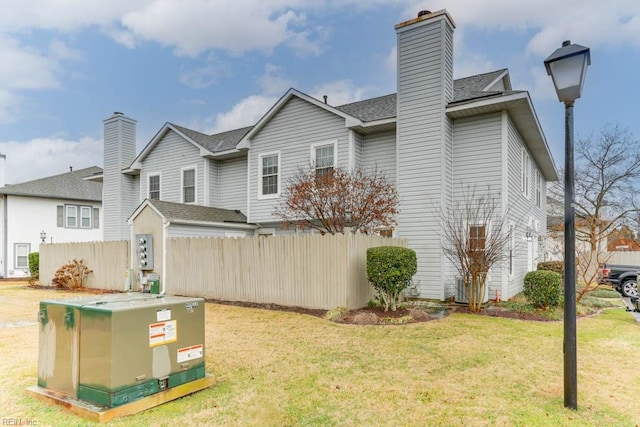 rear view of house featuring a lawn