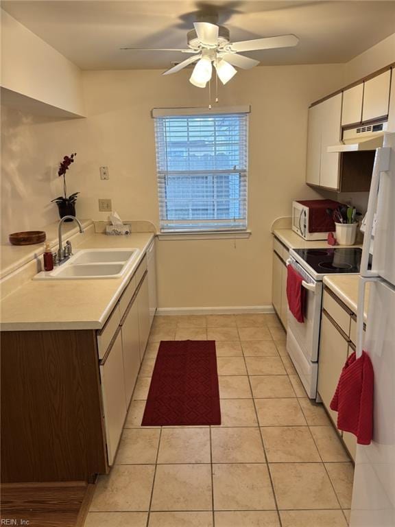 kitchen with white cabinetry, sink, light tile patterned floors, ceiling fan, and white appliances