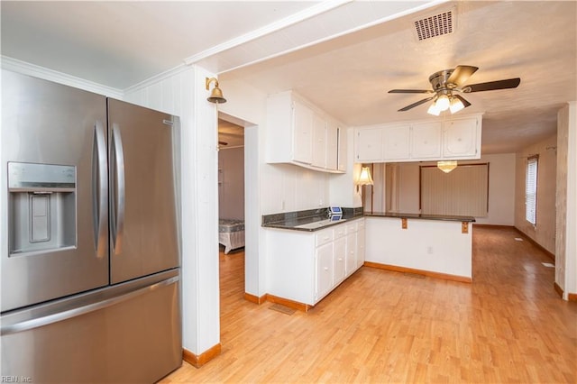 kitchen with stainless steel fridge, ceiling fan, white cabinetry, kitchen peninsula, and light wood-type flooring