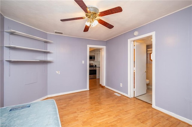 empty room featuring ceiling fan and light hardwood / wood-style flooring