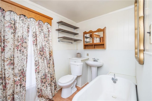 bathroom with crown molding, sink, hardwood / wood-style flooring, and toilet