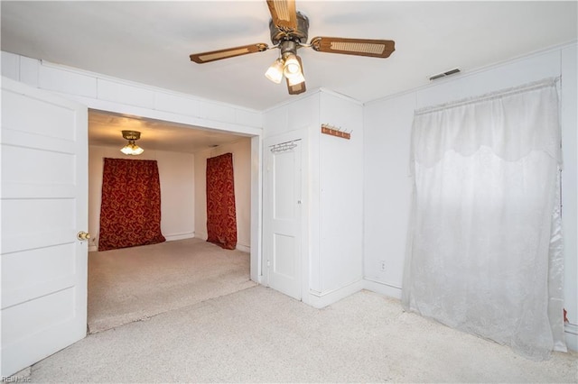 empty room featuring light carpet and ceiling fan