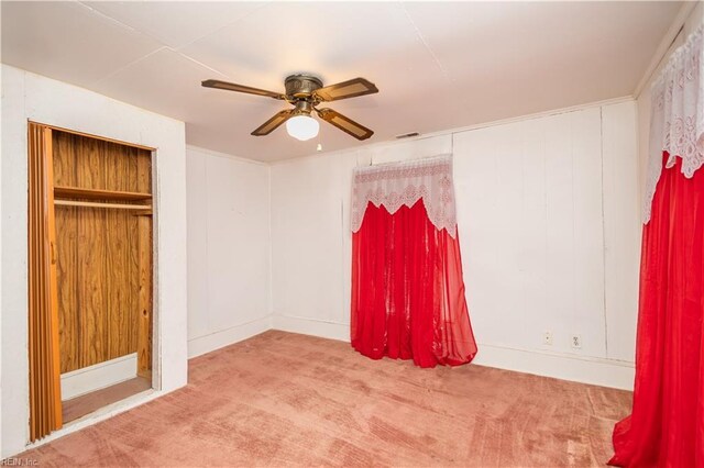 unfurnished bedroom with ceiling fan and carpet