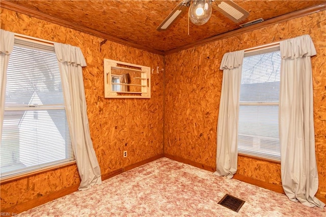 empty room featuring crown molding and ceiling fan