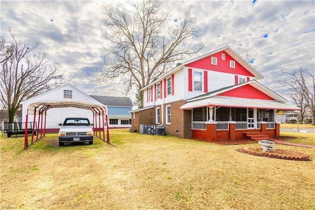 view of front facade featuring a carport, a front lawn, covered porch, and central air condition unit