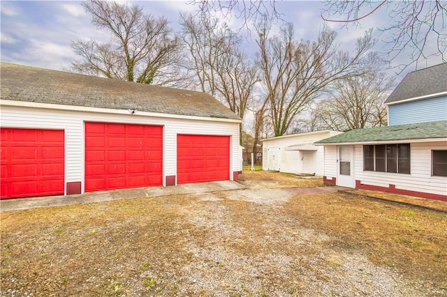 garage featuring a lawn