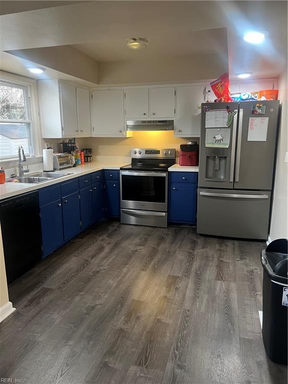 kitchen featuring blue cabinets, sink, appliances with stainless steel finishes, dark hardwood / wood-style floors, and white cabinets