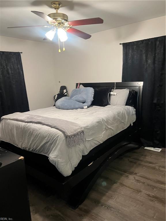 bedroom with ceiling fan and wood-type flooring