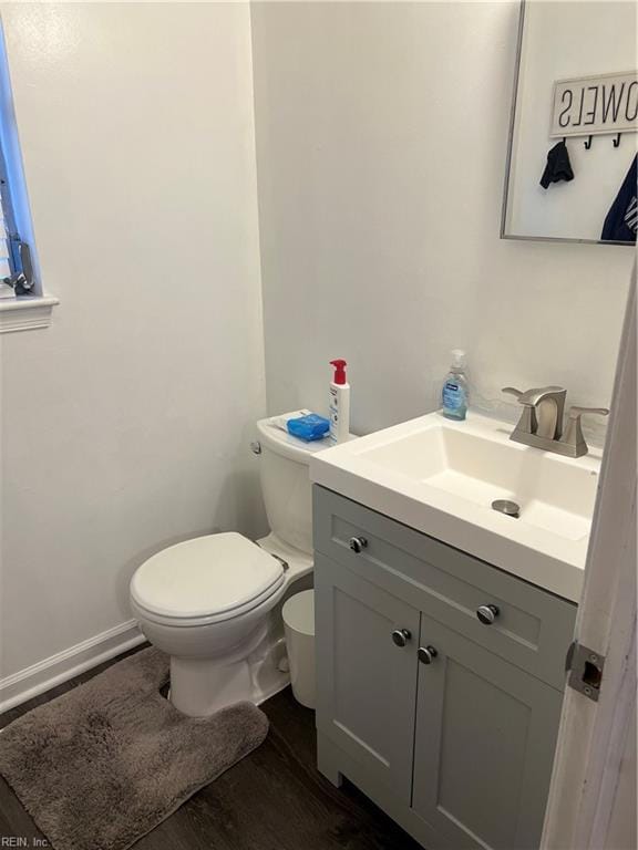 bathroom featuring vanity, hardwood / wood-style floors, and toilet