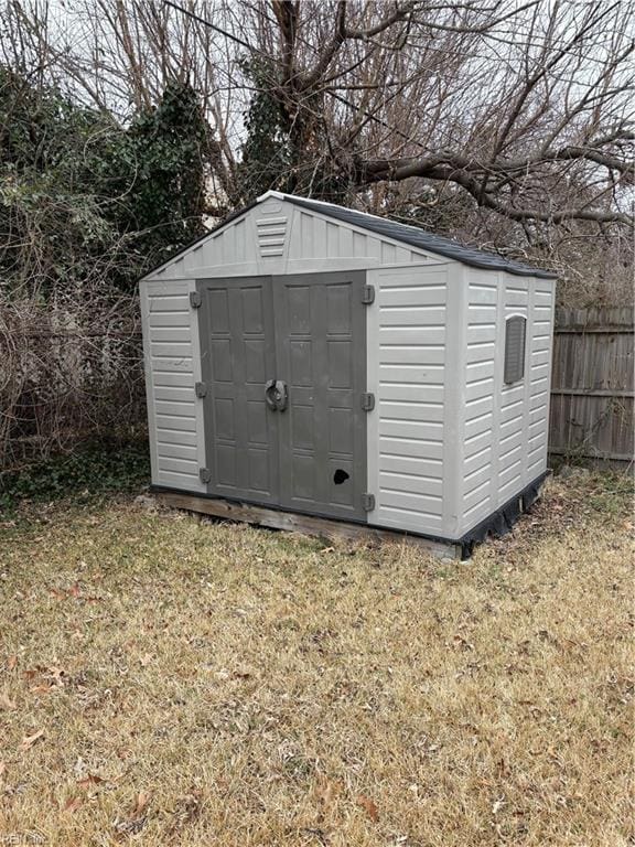 view of outbuilding with a lawn