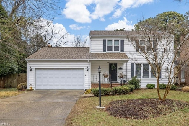 view of front of property with a garage and a front yard