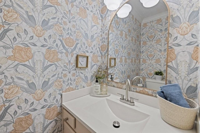 bathroom with crown molding, vanity, and toilet