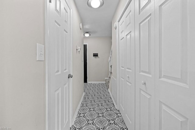 hall with light tile patterned floors