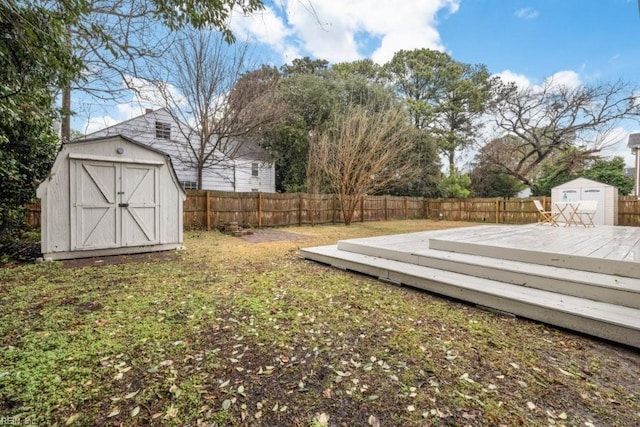 view of yard with a wooden deck and a shed