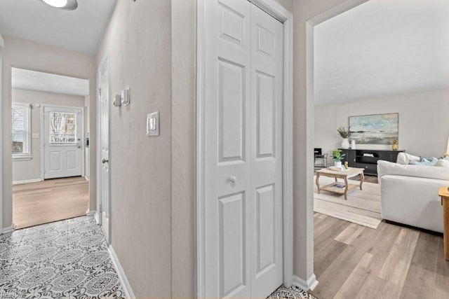 corridor with light hardwood / wood-style floors